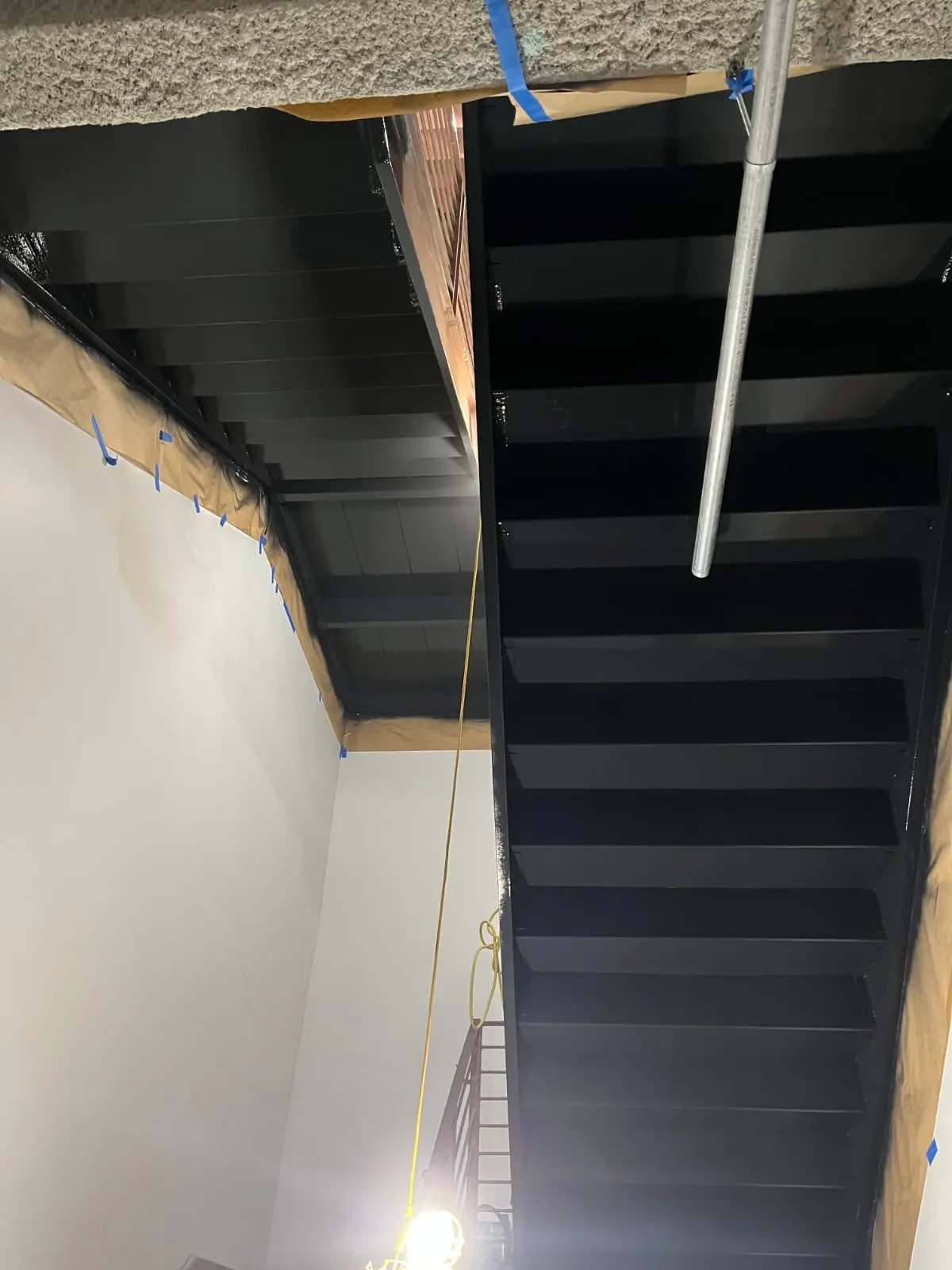 Commercial ceiling structure coated in black