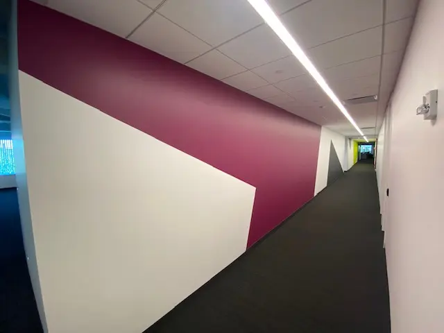 Commercial corridor with burgundy and white geometric wall design