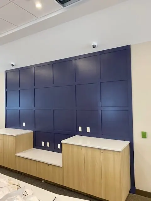Completed commercial feature wall in deep navy