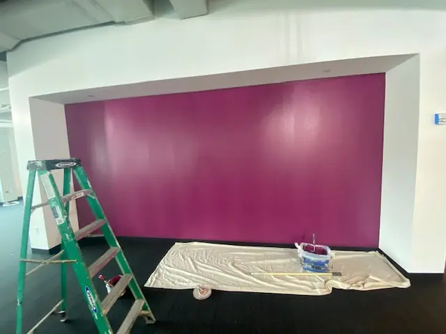Commercial accent wall painted in a rich magenta finish