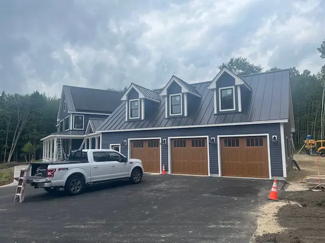 Gray residential exterior with finished garage doors