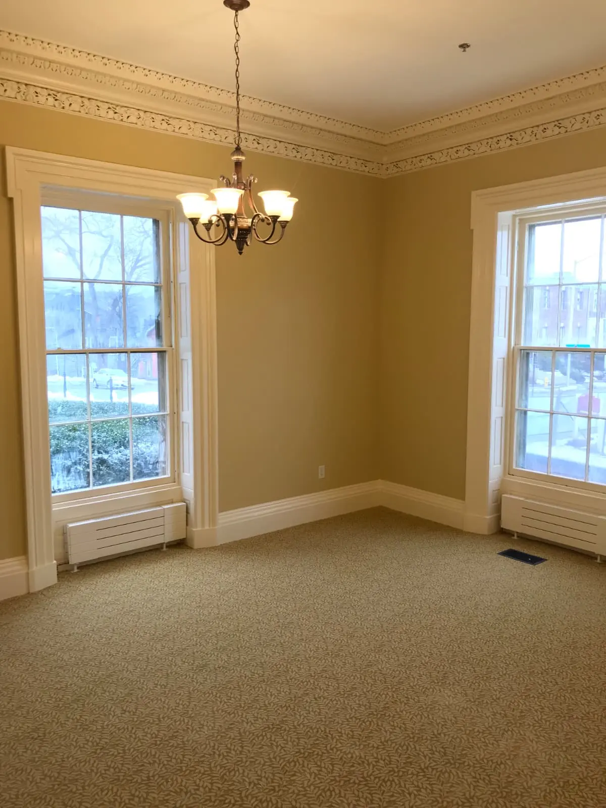 Historic room with freshly painted walls and ornate white trim