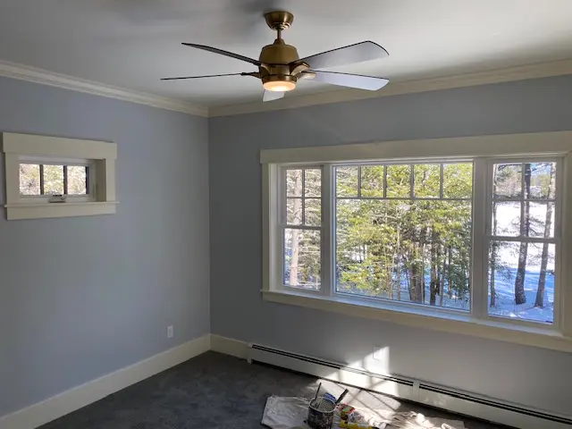 Residential interior painting with blue walls and white trim