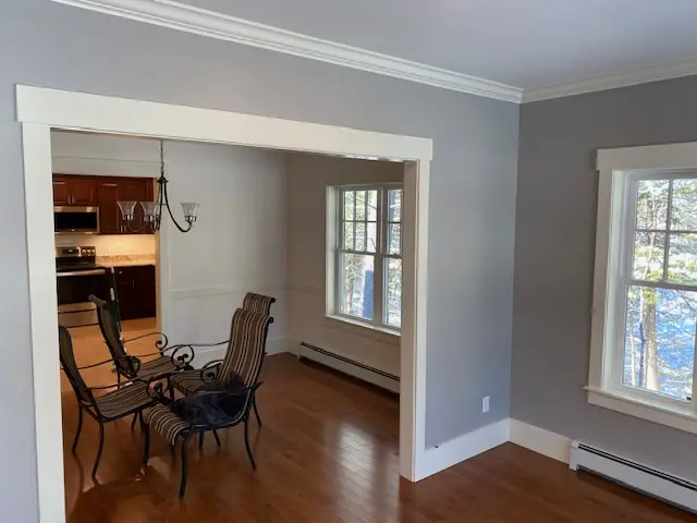 Gray dining and living area with crisp white trim