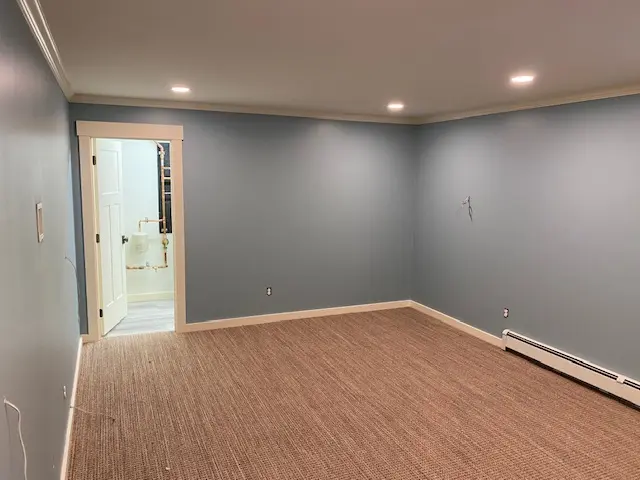 Finished gray residential room with white crown molding