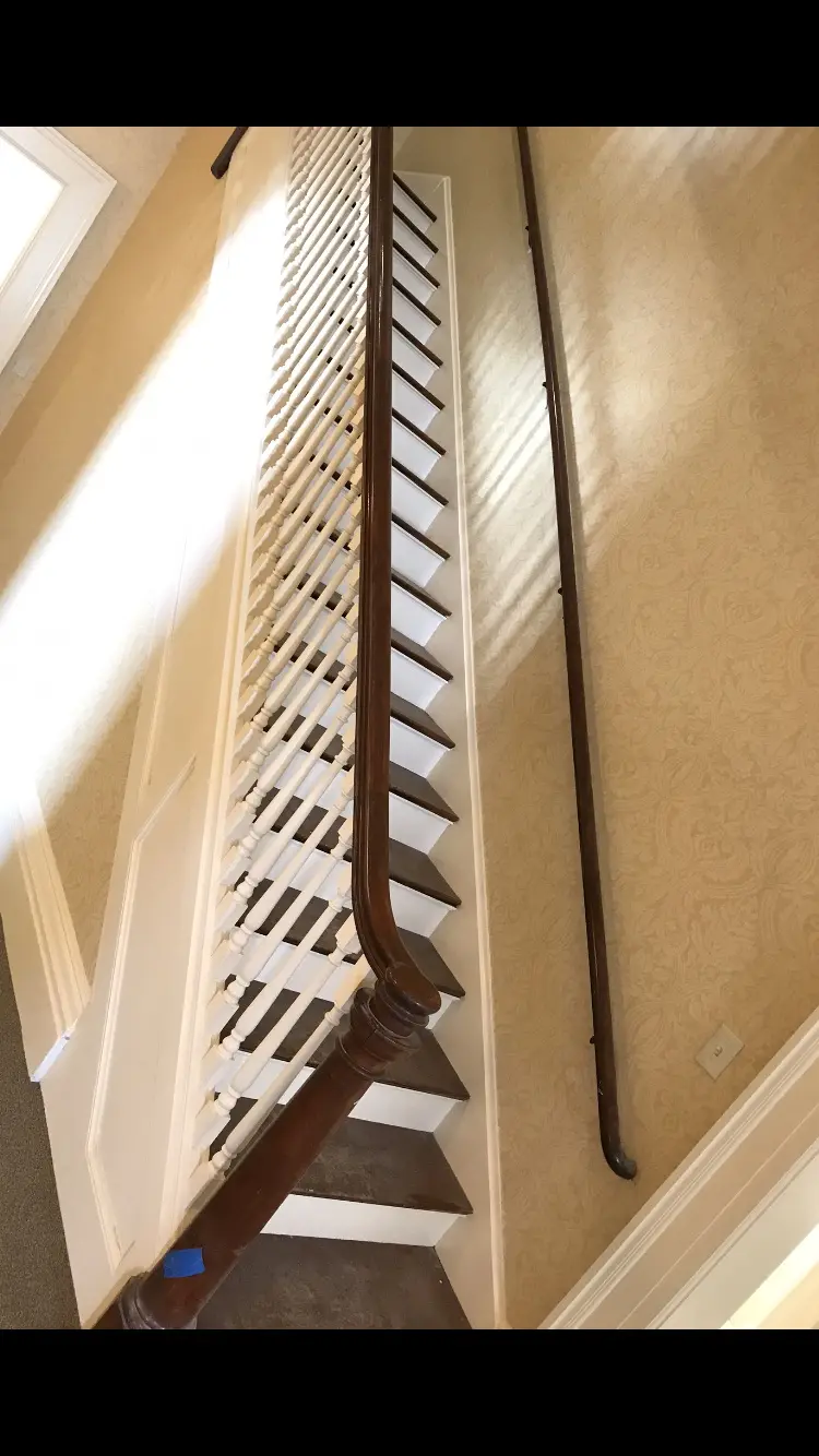 Residential staircase painting and wood finish detail