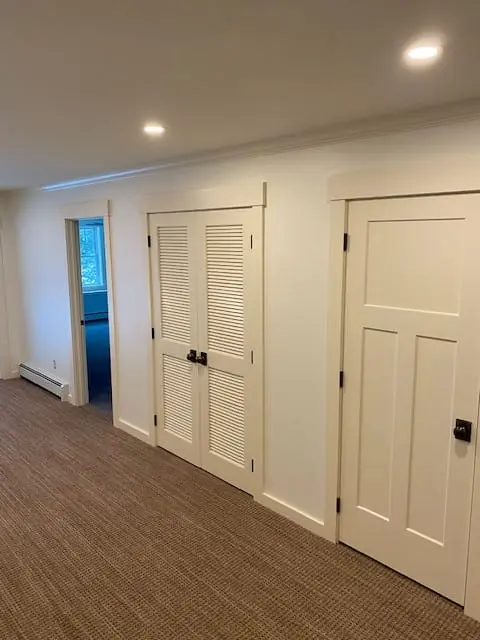 Residential hallway with white doors and trim
