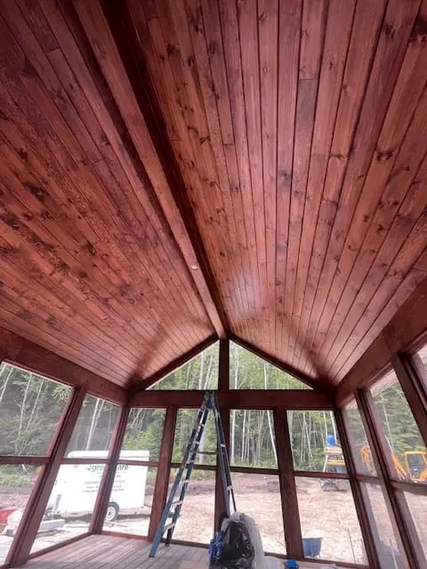 Warm stained wood ceiling in a screened porch